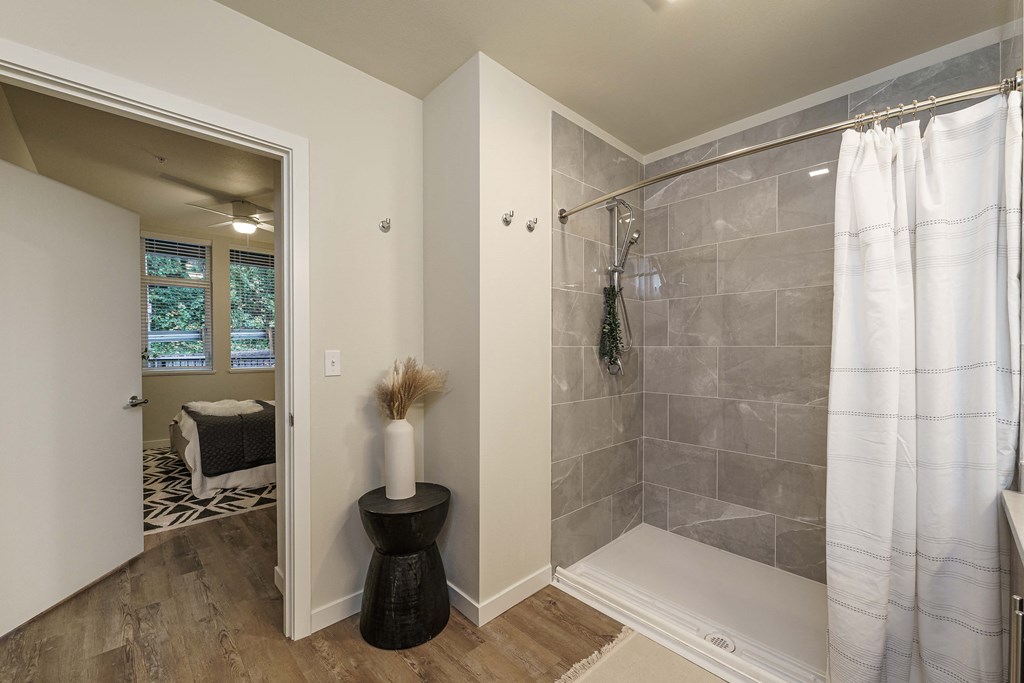 a bathroom with a shower with a white shower curtain