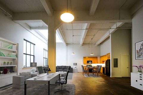 A modern open plan office and living space with a kitchen area.