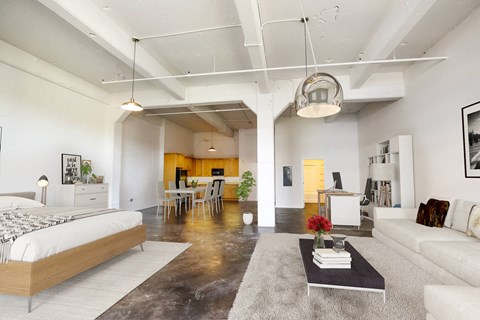 A modern living room with a large bed and a coffee table.
