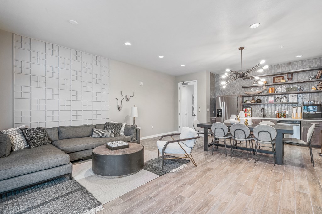 a living room with a couch and a table with chairs