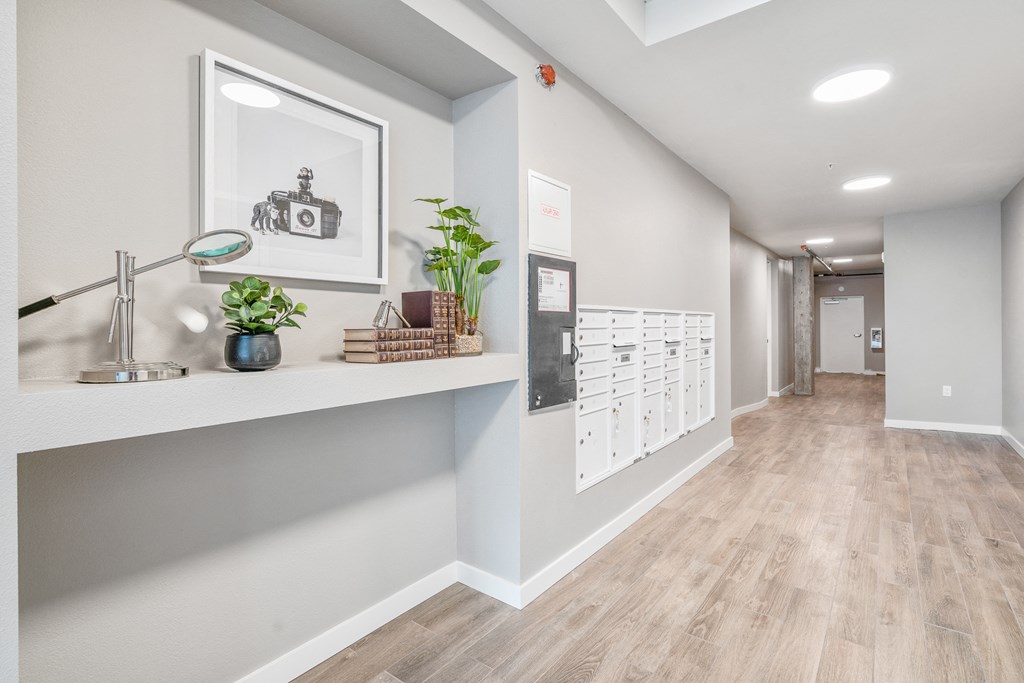 a corridor with a desk and mailboxes at the whispering winds apartments in pearland, tx
