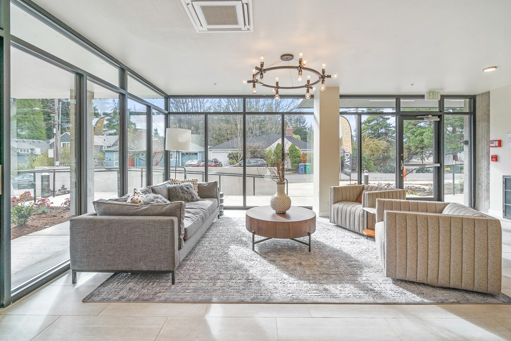 a living room with couches and chairs and a coffee table with a vase on it