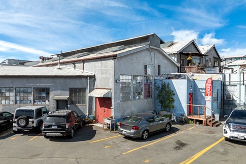 A parking lot with cars and a building in the background.