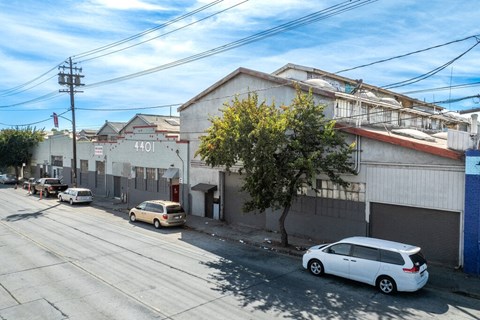 A street view with a white car parked on the side of the road.