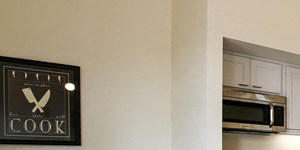 staged living room with view of kitchen