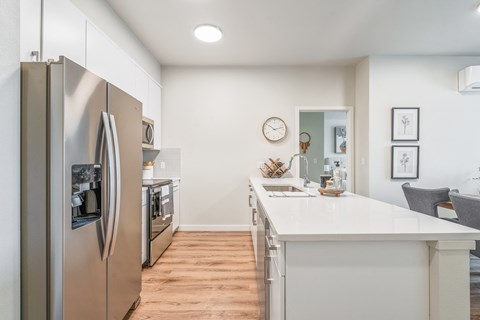 a kitchen with stainless steel appliances and a white counter top