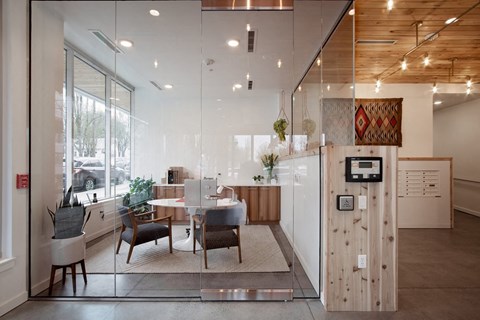 the kitchen and dining area of a modern home with a large window and a table