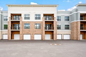 A large building with a parking lot in front.