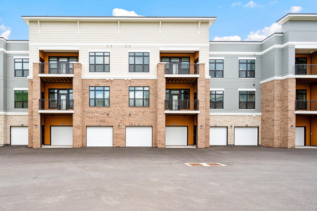 A large building with a parking lot in front of it.