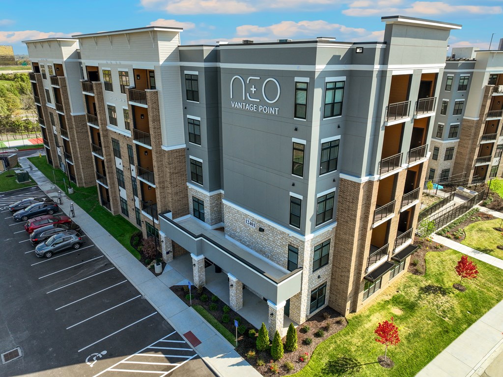 an aerial view of a large apartment building with a parking lot