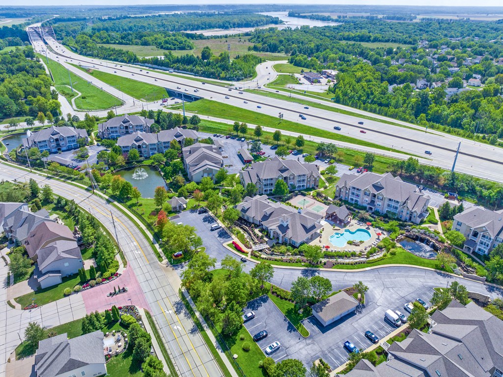 an aerial view of a neighborhood with houses and a swimming pool