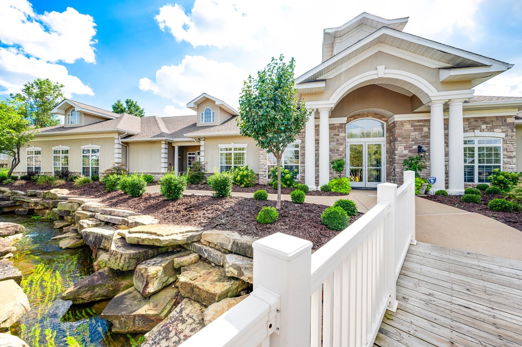 a home with a waterfall in the front yard