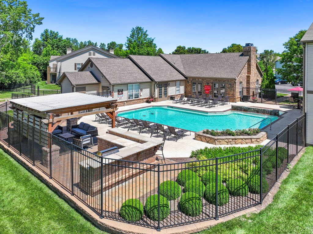 a backyard with a pool and a house with a patio