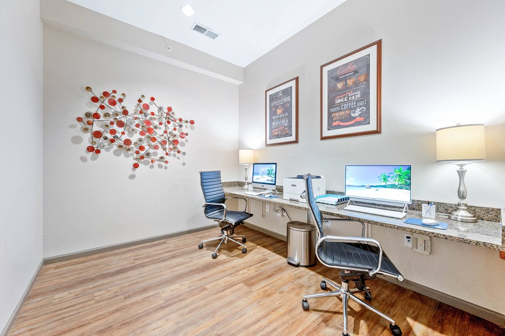 a room with two computers and two chairs