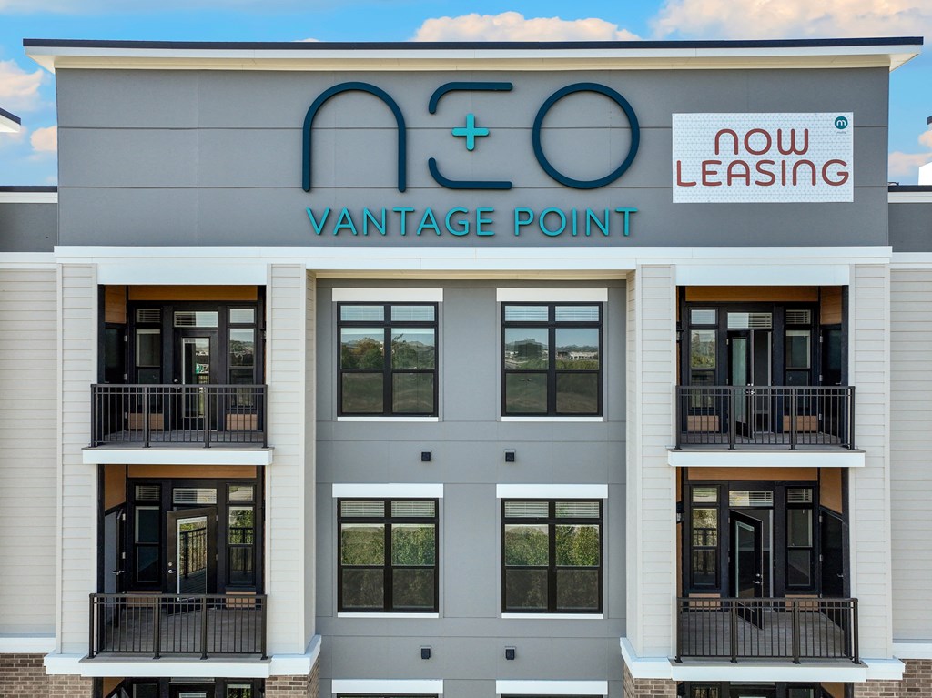 the front of a building with windows and a sign for vantage point