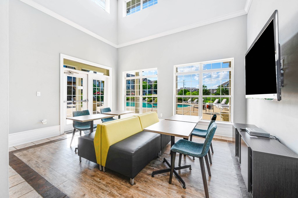 a room with a table and chairs and a television
