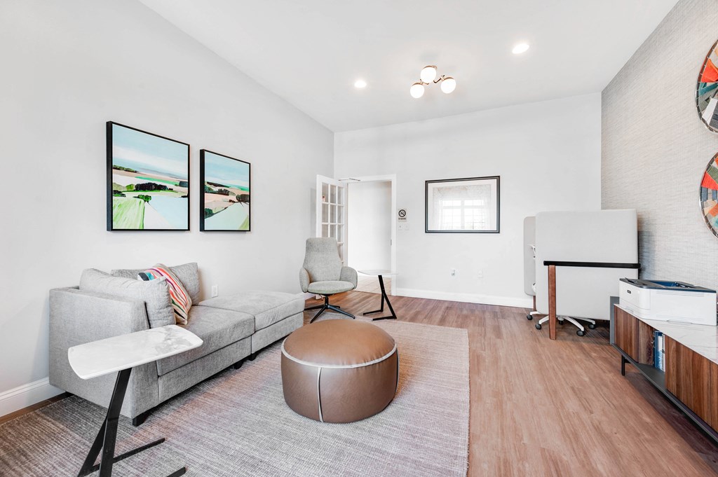 a living room with white walls and hardwood floors