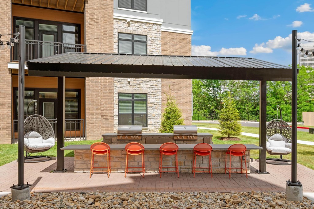 A patio with a table and chairs under a roof.