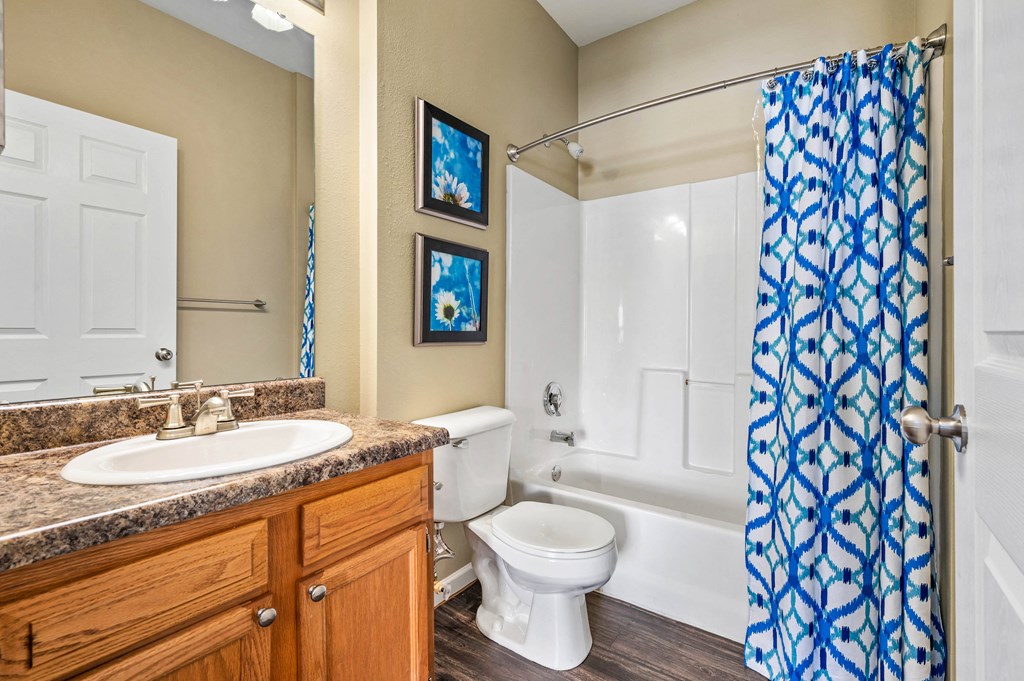 a bathroom with a sink toilet and shower