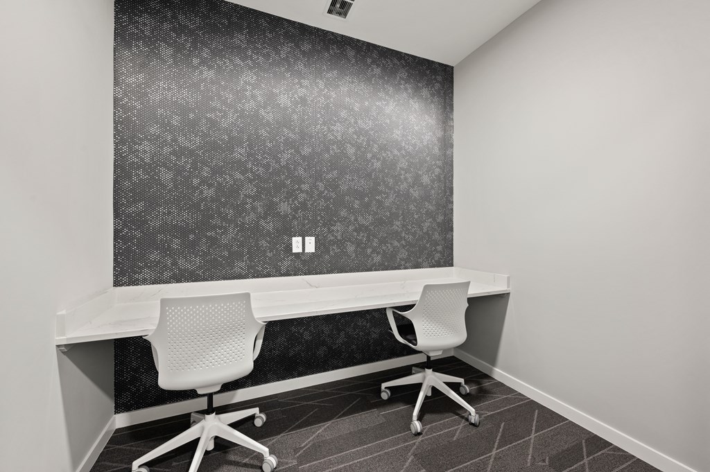 an office with two desks and two chairs