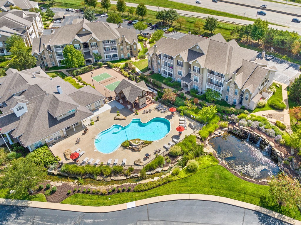 an aerial view of a resort style pool and community