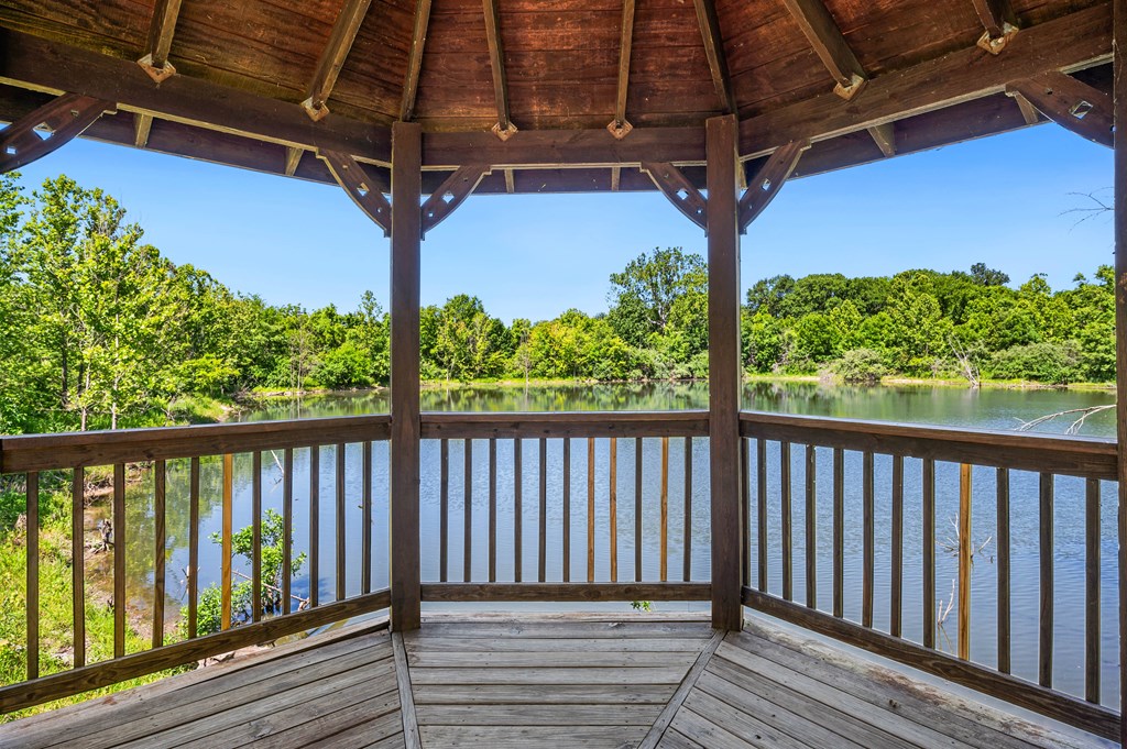 a view of a lake from the porch of a cabin