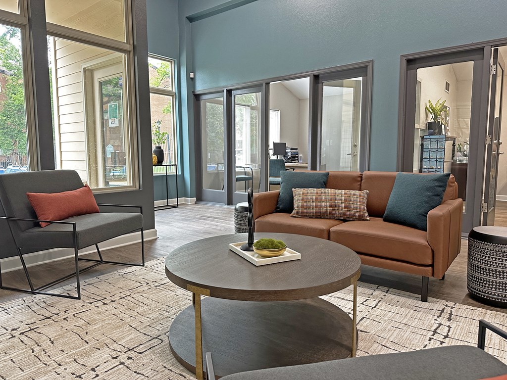 a living room with a couch and chairs and a coffee table