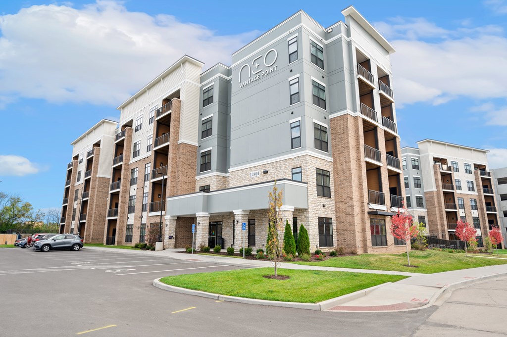 an apartment building with a car parked in front of it