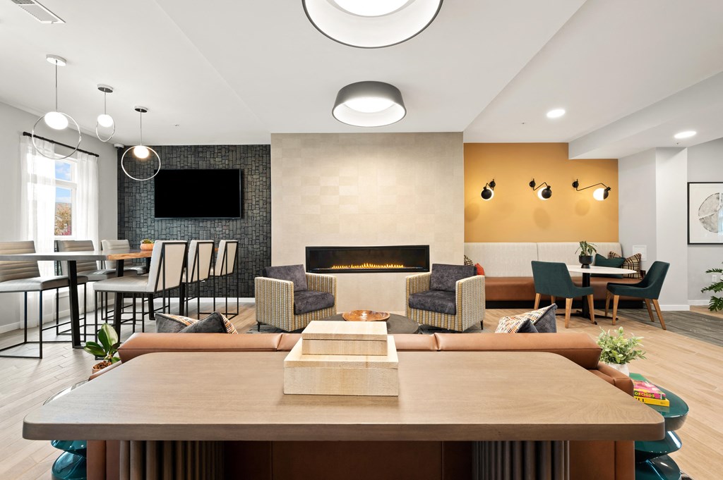 a living room with a fireplace and a table with chairs