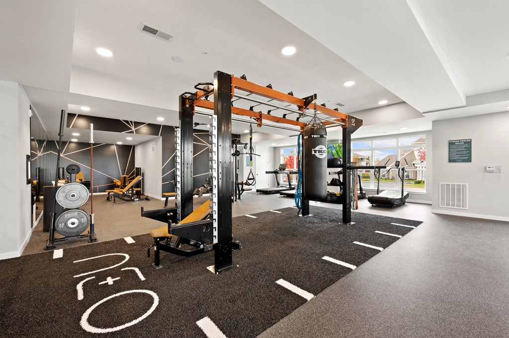 a gym with weights machines and other exercise equipment on a carpeted floor