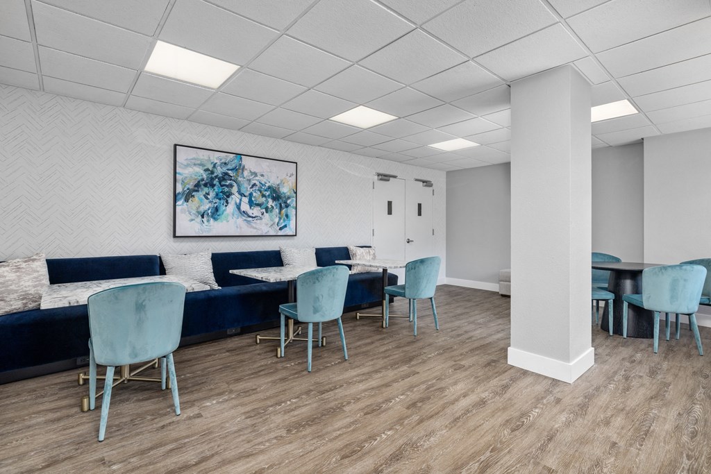 a waiting room with blue chairs and couches