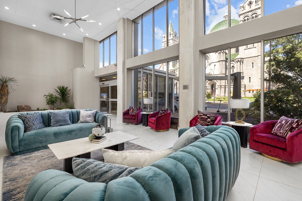 a living room filled with furniture and large windows