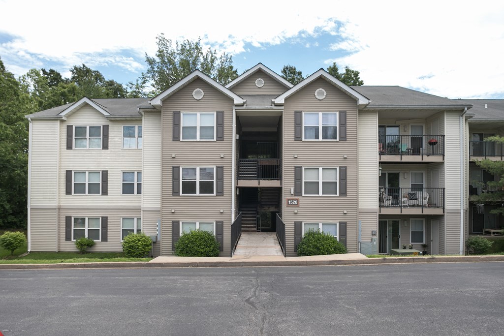 the outlook of an apartment building with a street in front of it
