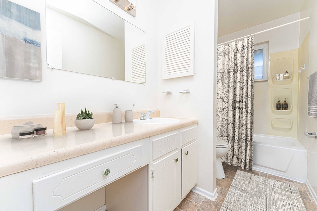 a bathroom with a shower and a sink and a mirror