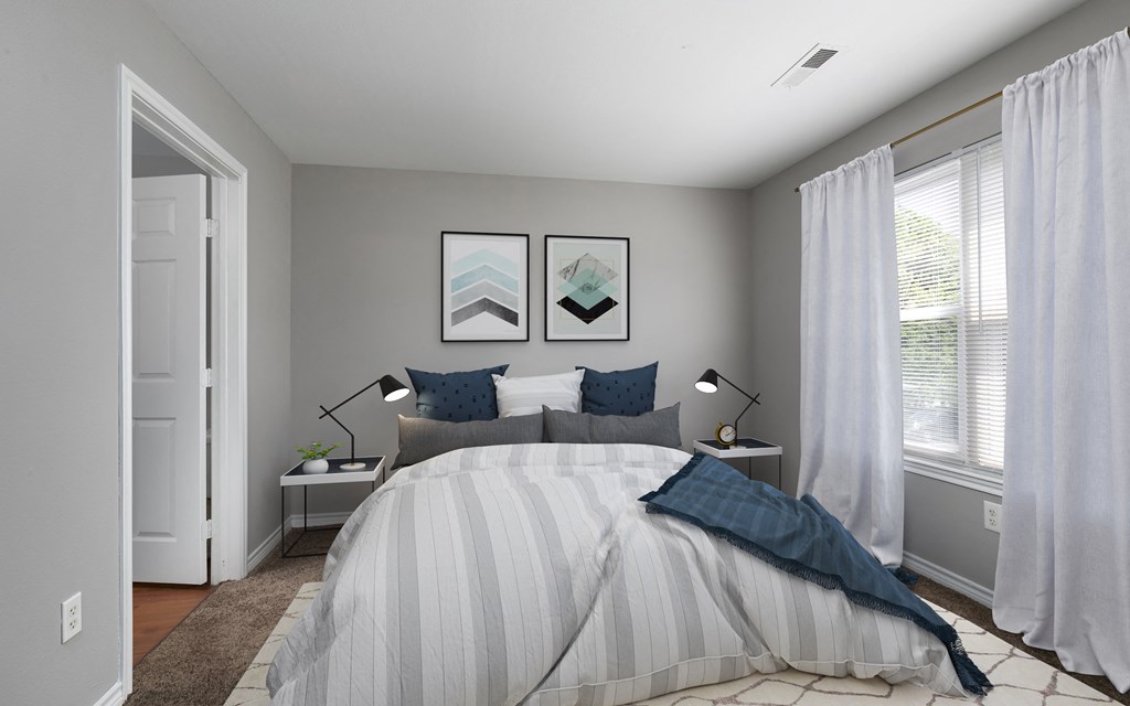 a bedroom with a bed and two windows