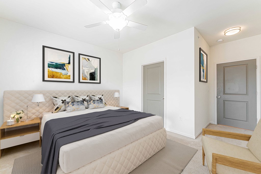 a bedroom with a large bed and a ceiling fan
