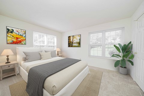 a bedroom with a bed and two windows