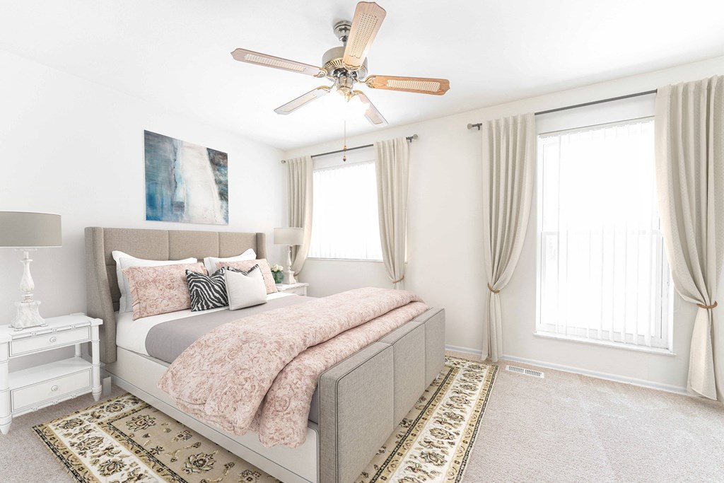 a bedroom with a bed and a ceiling fan
