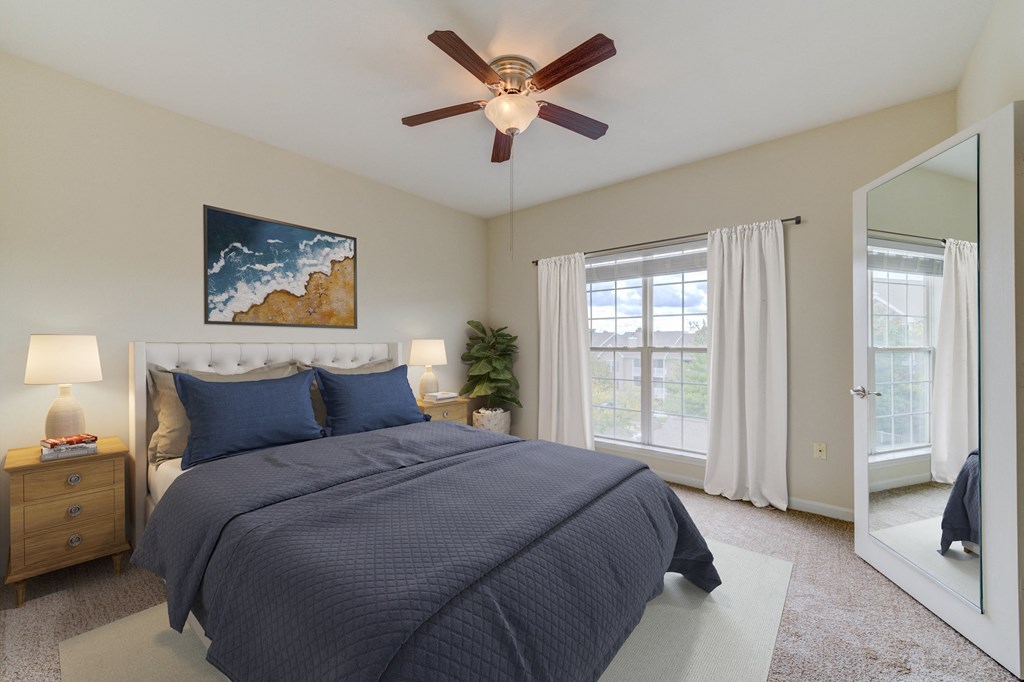 a bedroom with a bed and a ceiling fan