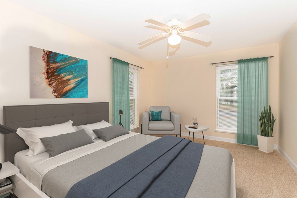 a bedroom with a large bed and a ceiling fan