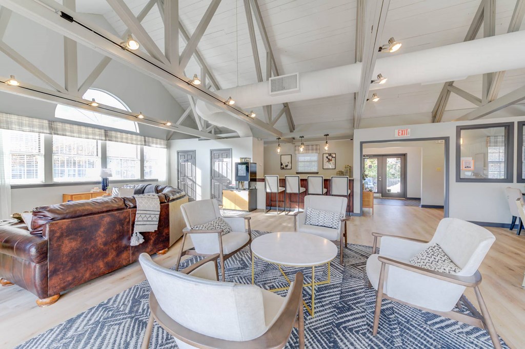 a living room with a couch and chairs and a table