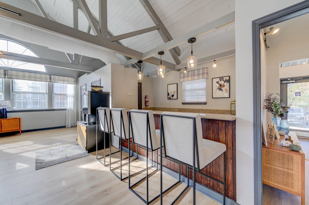 a dining room with a bar and a living room