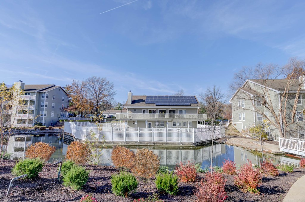 a house with a pond in front of it