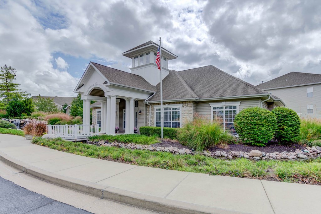 a house with a flag on a pole in front of it