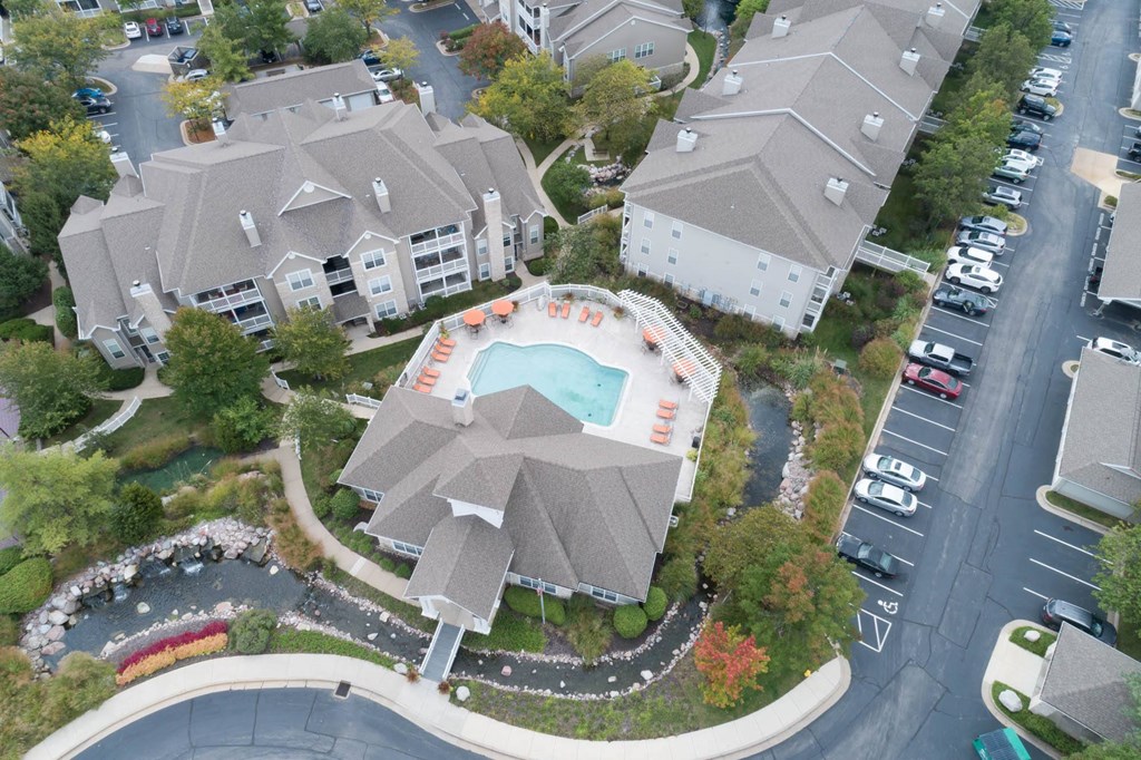 an aerial view of a swimming pool surrounded by houses