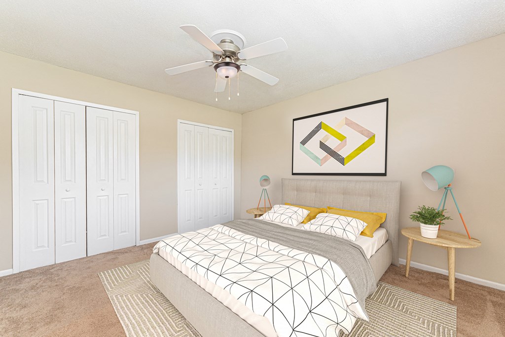a bedroom with a bed and a ceiling fan