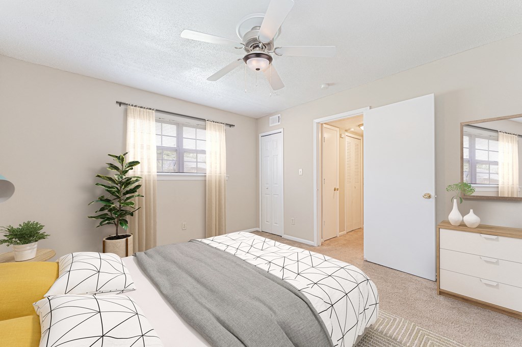 a bedroom with a bed and a ceiling fan
