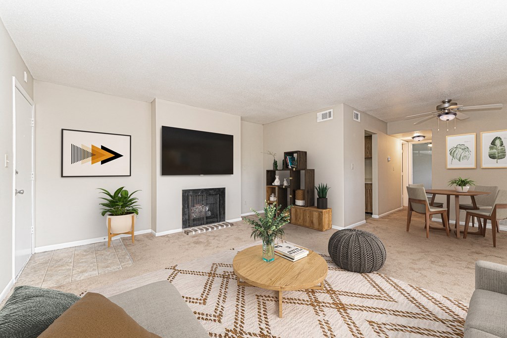 a living room and dining room with a table and a television