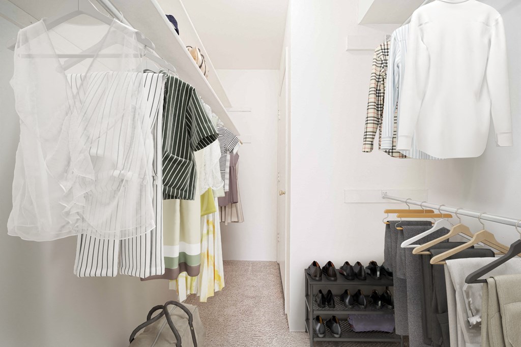 a white closet filled with clothes and shoes