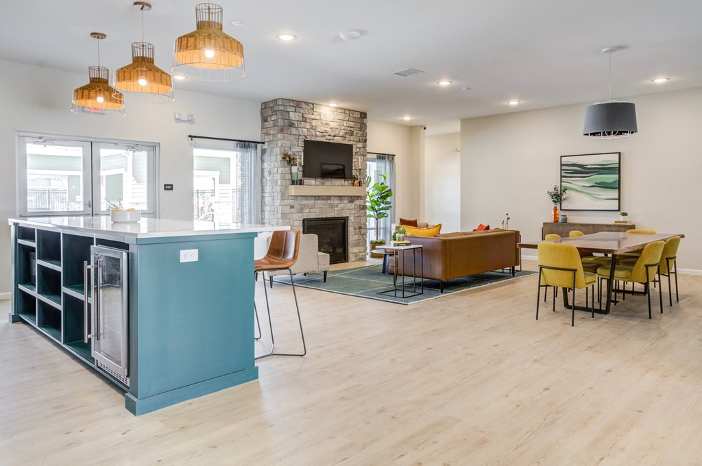 Citrine clubhouse lounge area with fireplace and large meeting table